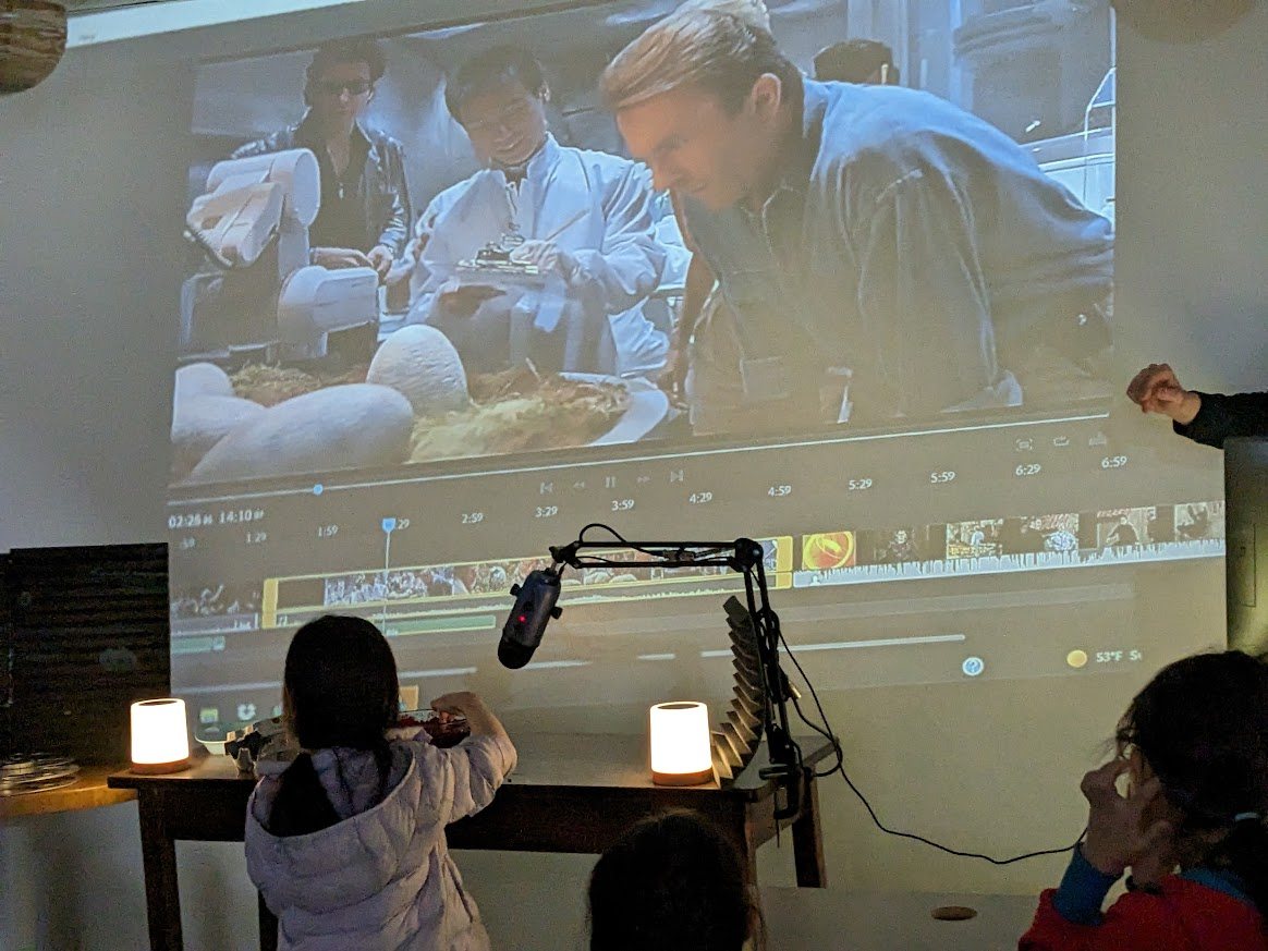 Student performing Foley sound in front of a large editing timeline