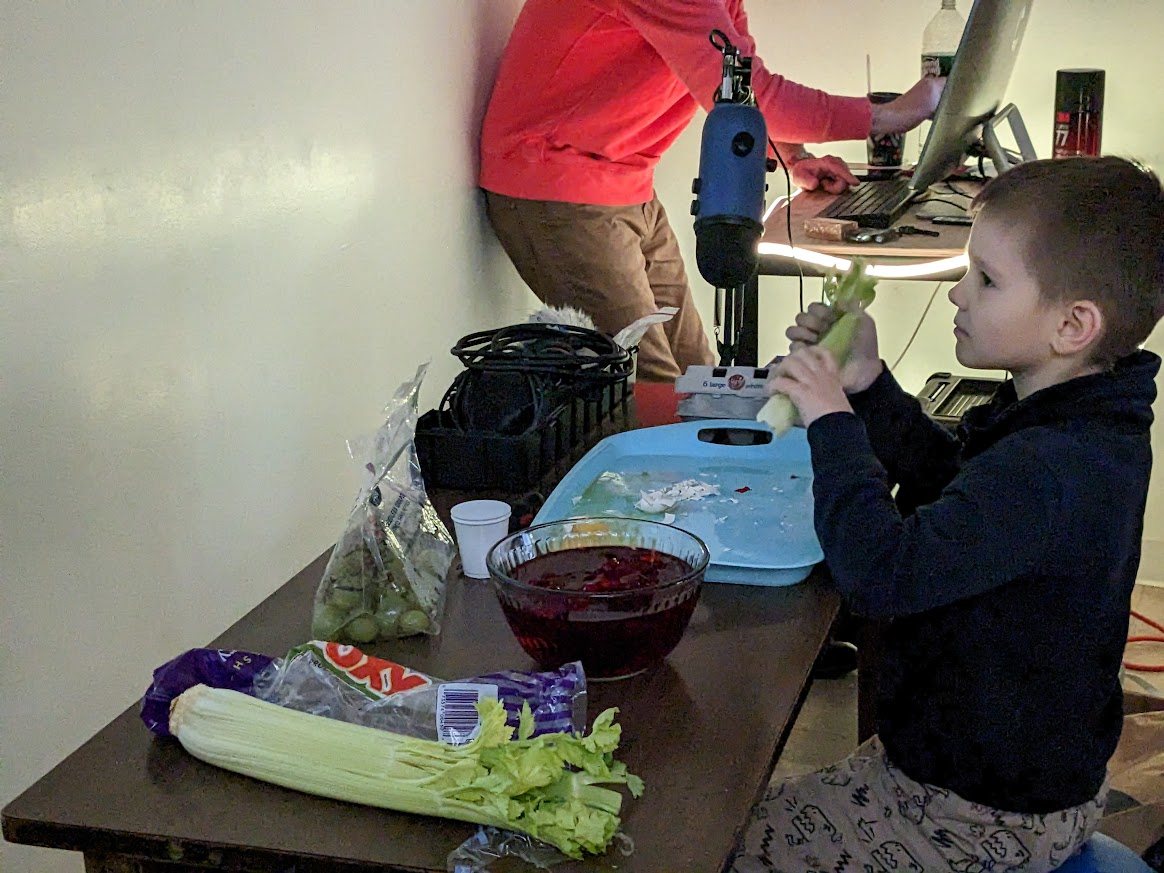 Student creating practical Foley sound with a microphone and props