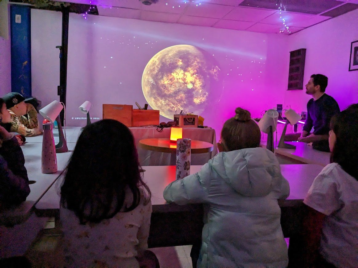 Students in an immersive space lesson with a giant projected planet