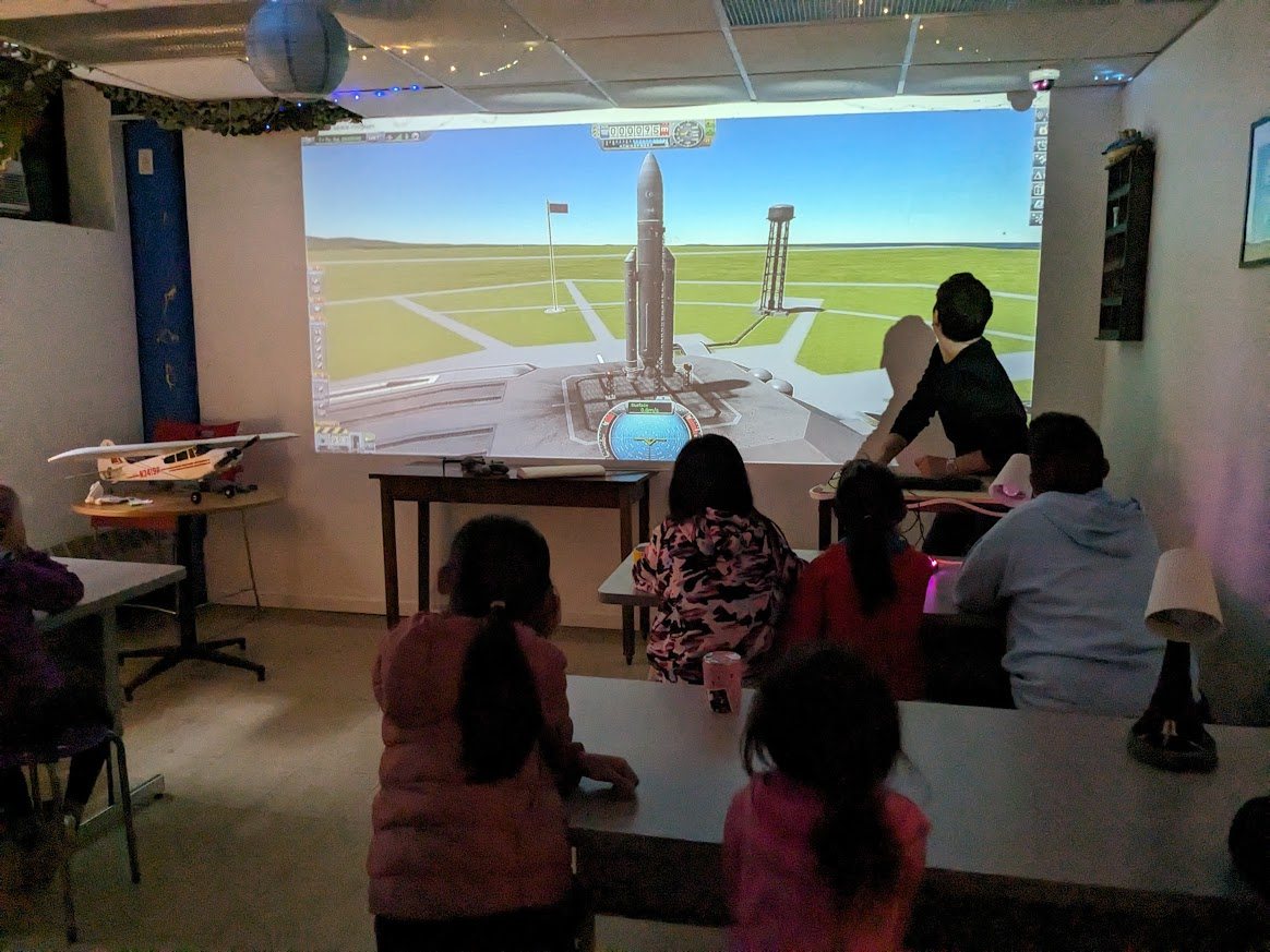 Class watching a rocket and flight simulation